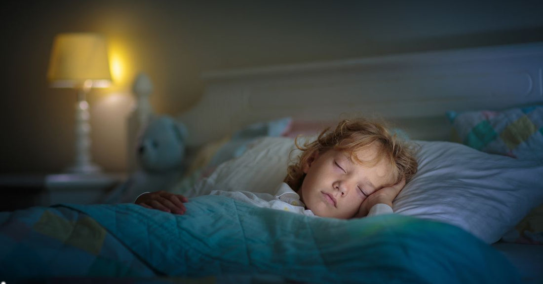 Child sleeping in dark bedroom