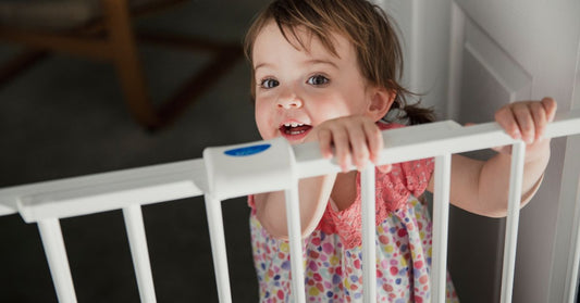 Kid Standing at a Saftey Gate⁠